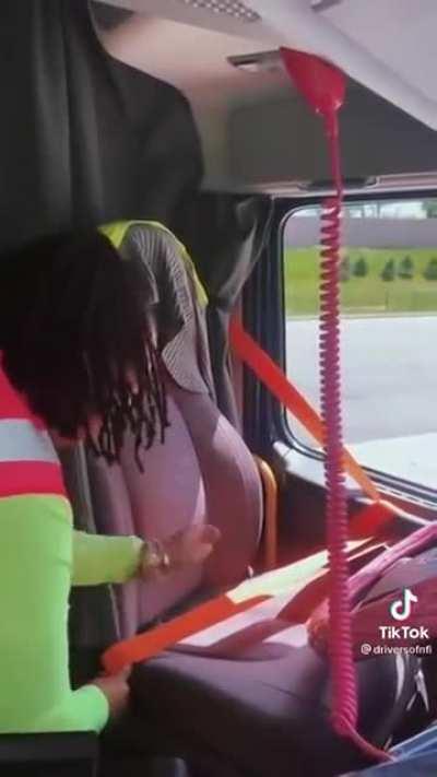 Trucker showing how to stay safe using a seat belt