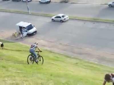 A man saves an idiot on bycicle from smashing into a parked car