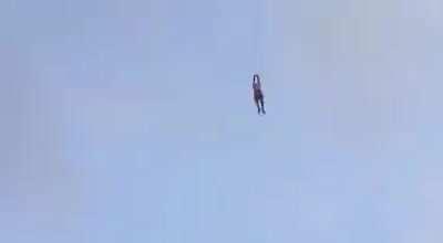 Man swept into the the air while flying a kite