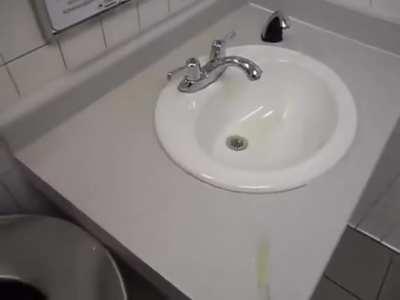 Guy pisses all over a public bathroom