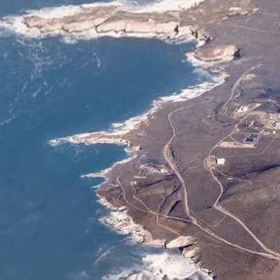 People on the beach waving at the satellite.