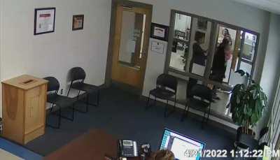 Mom, while holding her baby, assaults principal in TN.