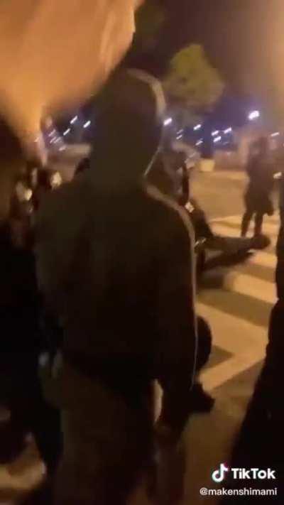 DC Police officer takes a knee and is dragged to his feet by other officers