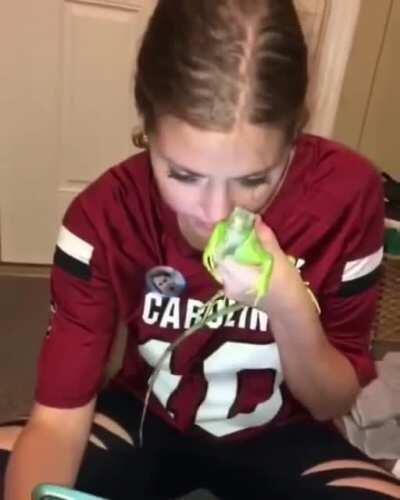 Drunk girl messing with iguana