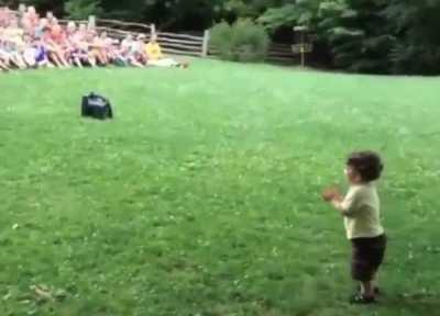 Little boy thinks the crowd gathered at the park for him.