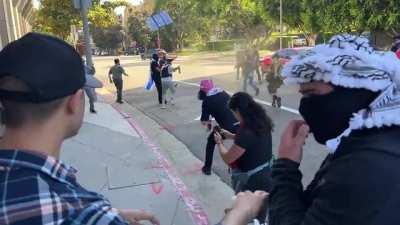 Palestine supporters chase, mace Israel supporters in Los Angeles.