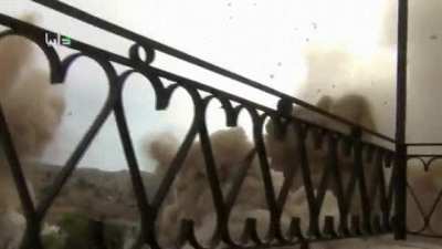 Cameraman almost struck by bomb.