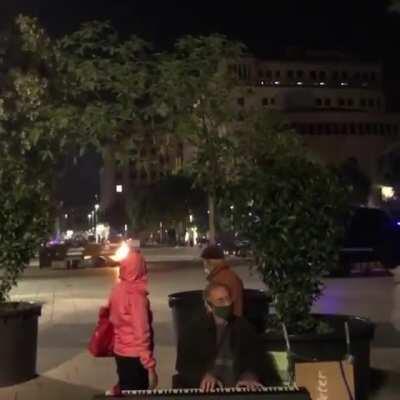 Piano player calmly keeps on playing during a heated protest in Barcelona