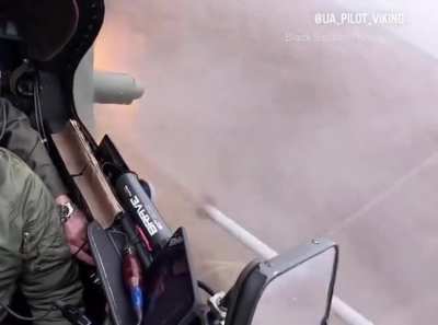 Ukrainian helicopter pilot fires rockets, turns away while shooting flares.