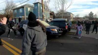 Portland Police trying to serve an eviction get pushed back by angry residents.