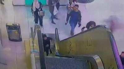 Girl stuck on escalator gets saved.