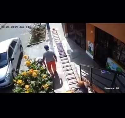 Man in wheelchair shakes a painters ladder because it was blocking the pavement