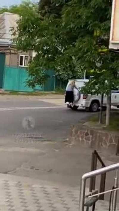 Just a woman behind a police car