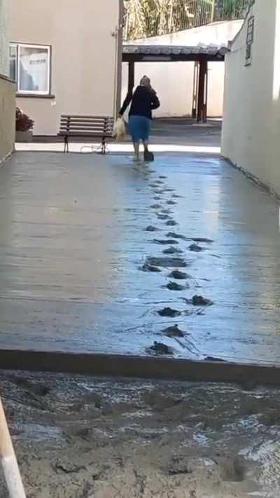 Lady decides to walk through wet cement