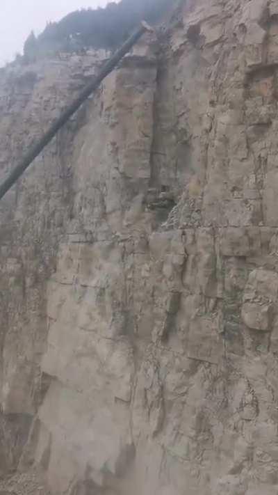 Excavator at work, earth mover for scale..