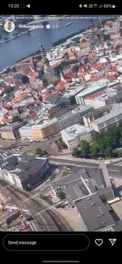 Latvian team circling around crowd of people