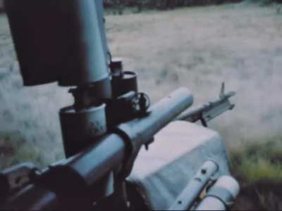 Huey door gunner sweeps the treeline with his M60 as what appears to be a Long-range reconnaissance patrol is evacuated in Vietnam