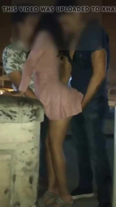 Two guys teasing a girl outside