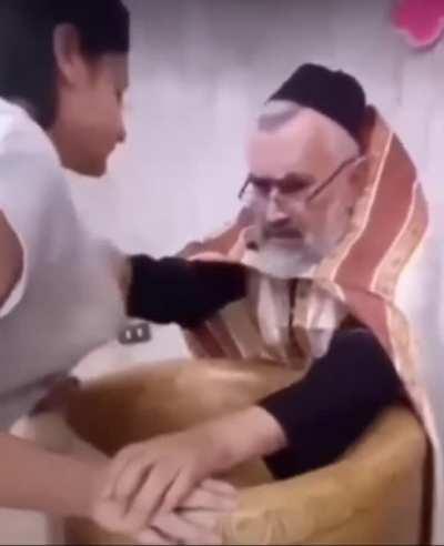 He is checking if she is blessed