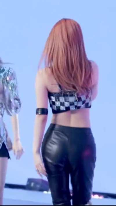 Yeji - red hair, black leather pants, b&w checkered top