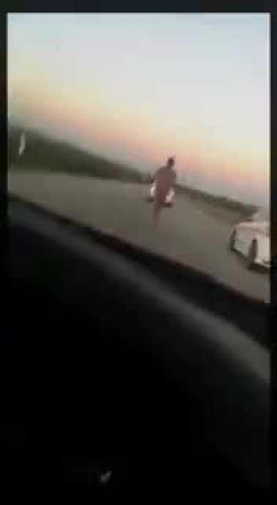 Man running naked on a highway