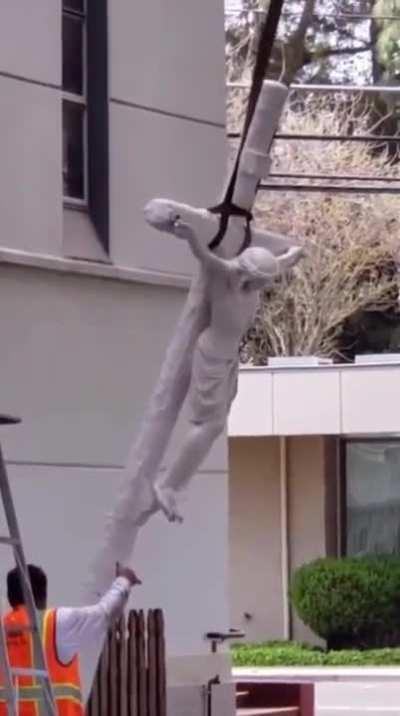 Moving a Jesus statue.