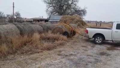 Trailer designed to pick up hay bales without having to own a bale loader truck