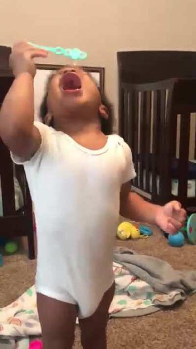 These twins trying to blow bubbles for the first time