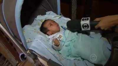 Coughing Baby (luckily no hydrogen bombs in sight), from a Brazilian news show