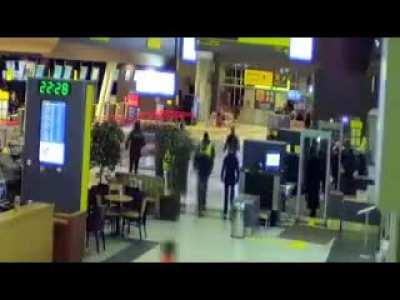 Car drives through what appears to be an airport. Sound on