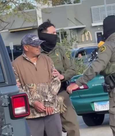 ICE agent points his gun at an unarmed woman during a kidnapping operation