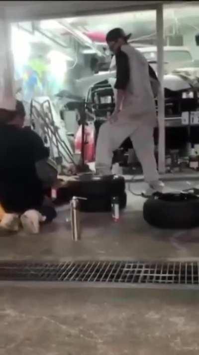 WCGW man stands on tire being inflated with fire
