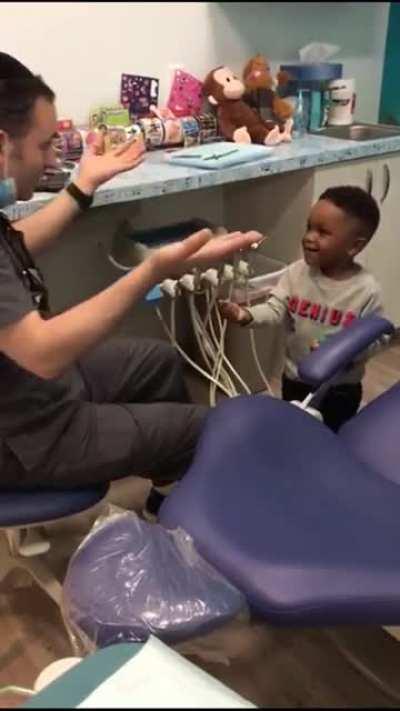 Dentist helps his nervous patient get comfortable before his checkup