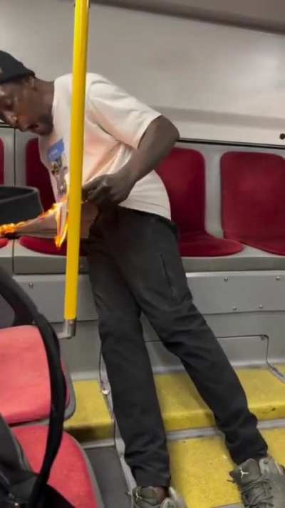 man sets his shirt on fire