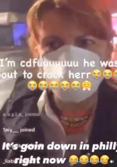 Rioter smashes up a Philadelphia police car window