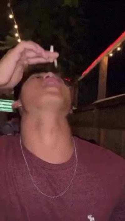 Holding A Cigarette Up To Your Mouth