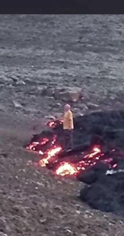 Standing on fresh lava for a photo..