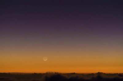 Moonset behind sea of clouds