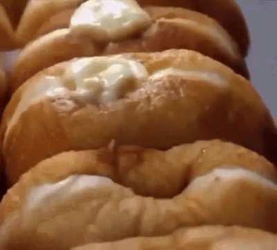 Baker makes cream-filled donuts
