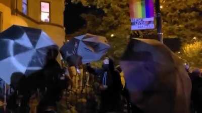 Man steals megaphone from BLM protestor. BLMers then storm his property, destroy his property, assault him. BLMers use umbrellas to block press from filming crimes.