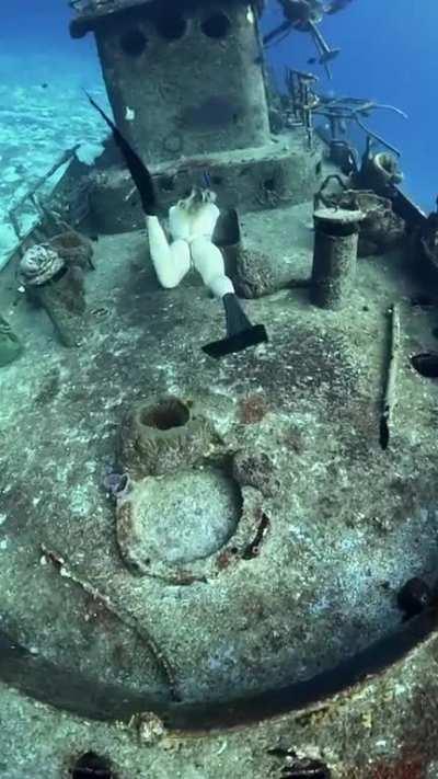Scuba dive into a sunken rusty ship