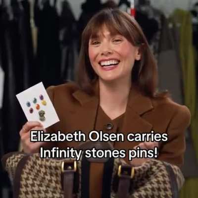 Lizzie carries Infinity Stones pins