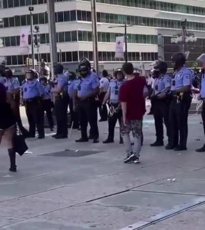 Protestor tempting cops with a donut
