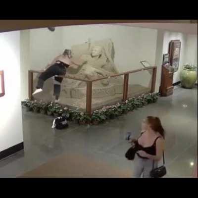 Girl destroys sand sculpture