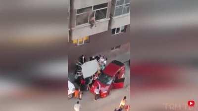 People help man down from burning building.
