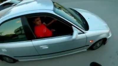 Two guys get sprayed like flys while trying to beat the motorcycle dude