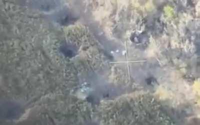 Ukrainian drone captures video of Ukrainian artillery landing just adjacent to Russian armored vehicle with troops on top, in east of Ukraine.