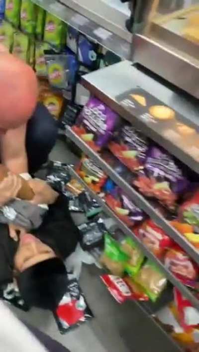 guys fighting in a gas station