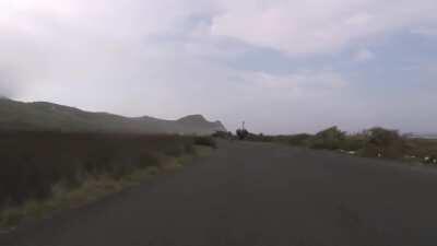 Cyclist chased by an Ostrich