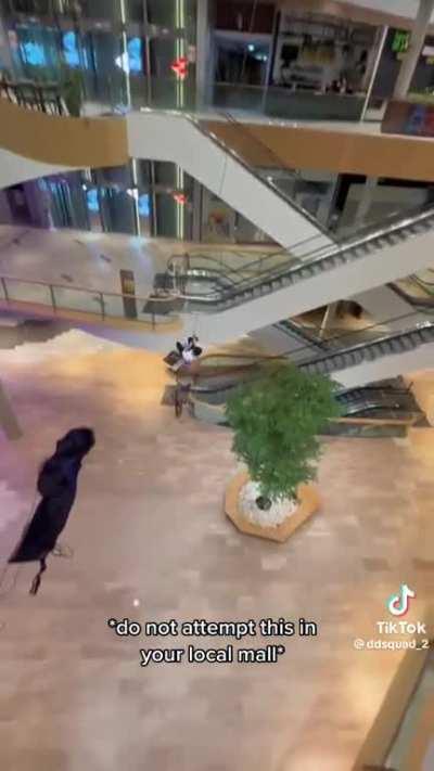 Man jumps 3 stories held up by a sled attached to a rope